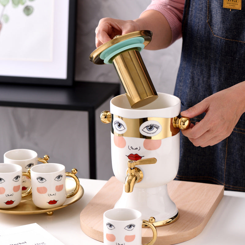 Decorative ceramic beverage dispenser with tap, hand-painted face and gold-finished lid