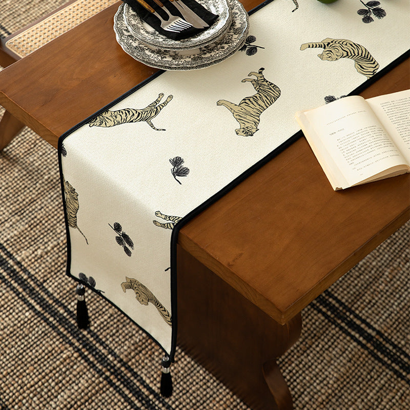 Woven cotton-linen table runner with tiger print and decorative tassels