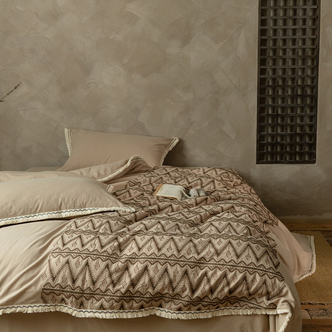 Premium cotton bedding set with woven ethnic overlay and fringes