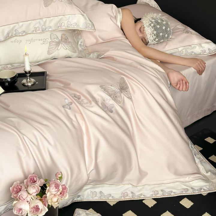 Satin bedding set with embroidered butterfly motif and silk-matte finish