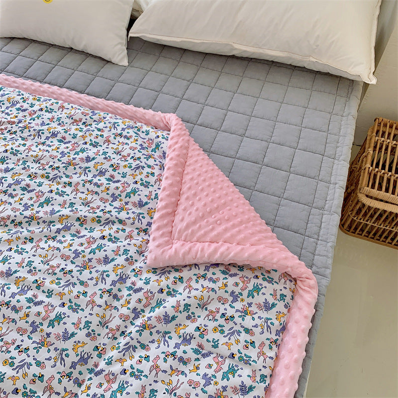 Children's quilt with colorful dinosaur print and soft minky border