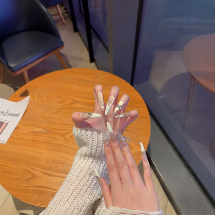 Elegant Stiletto Nail Extensions with Decorative Designs