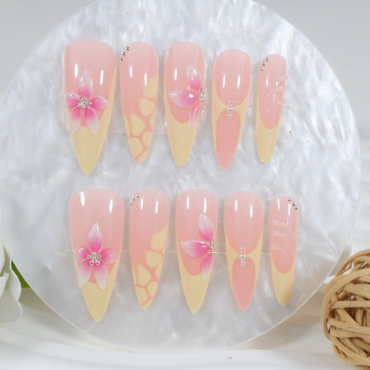 Acrylic nail set with elegant floral pattern and shimmering accents Kalsten