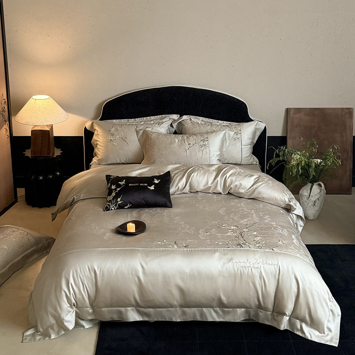 Romantic satin bedding set with embroidered floral design, ruffle and pillowcases
