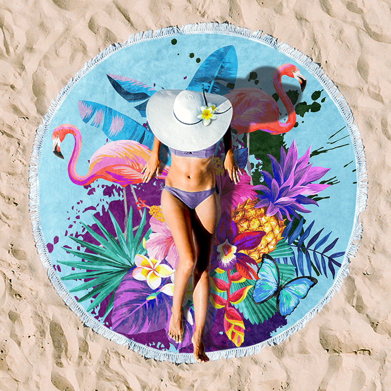 Round beach towel with colorful, tropical floral pattern and fringe decoration Kalsten