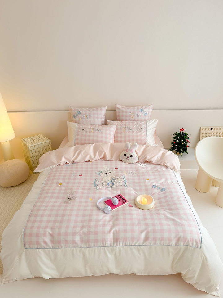 Playful cotton bedding set with embroidered bunny and cherry motif including decorative pillow