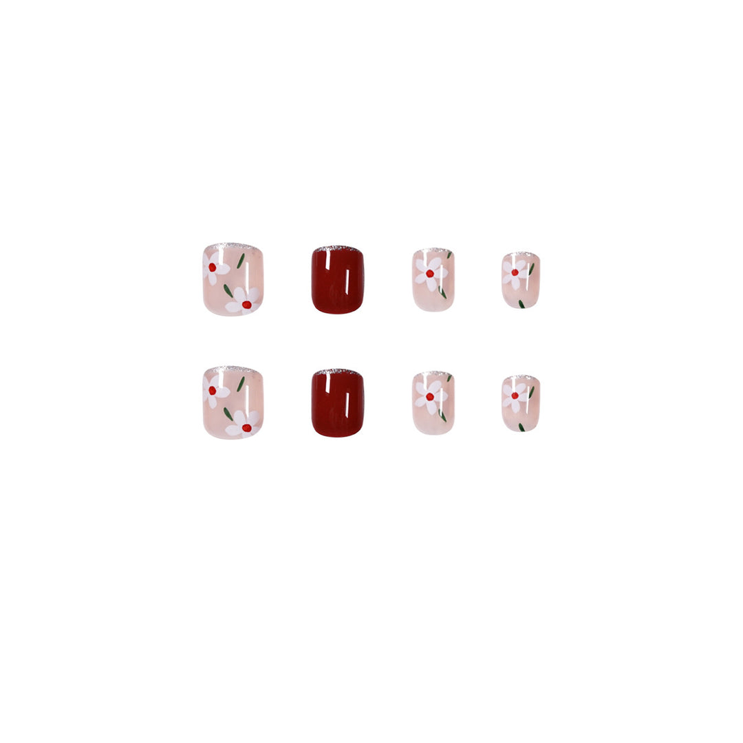 Artful nail art with floral motifs and glitter accents Kalsten