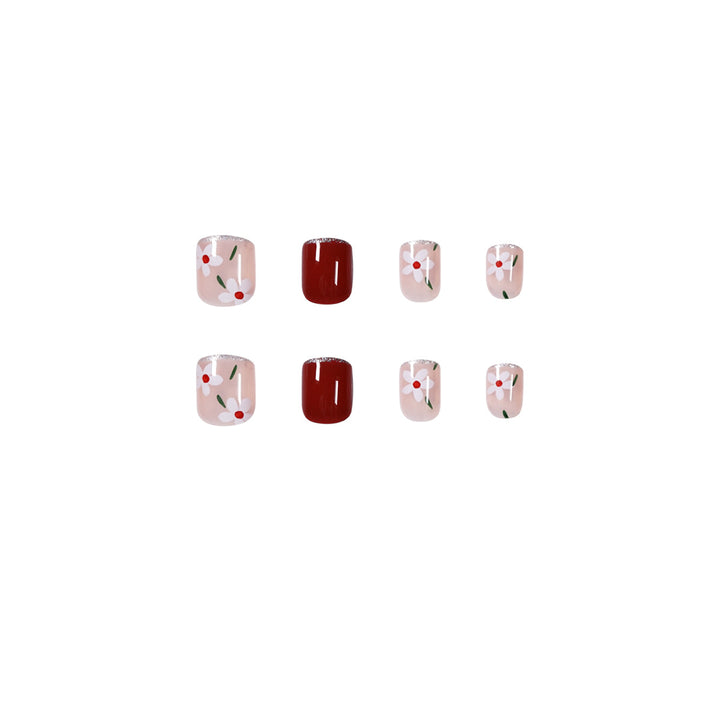 Artful nail art with floral motifs and glitter accents Kalsten