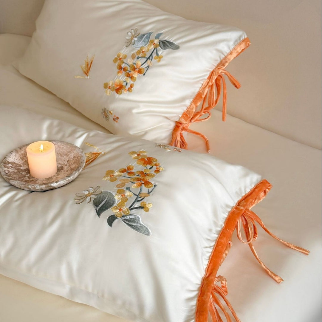 Luxurious satin bedding set with floral embroidery and bow appliqué