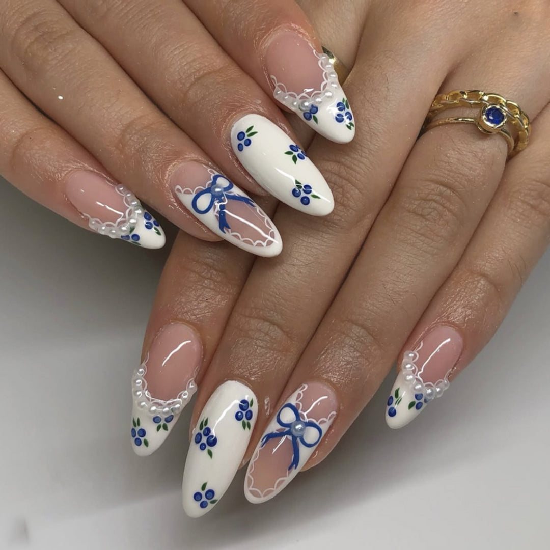 Artful nail art with floral accents and bow embellishment Kalsten