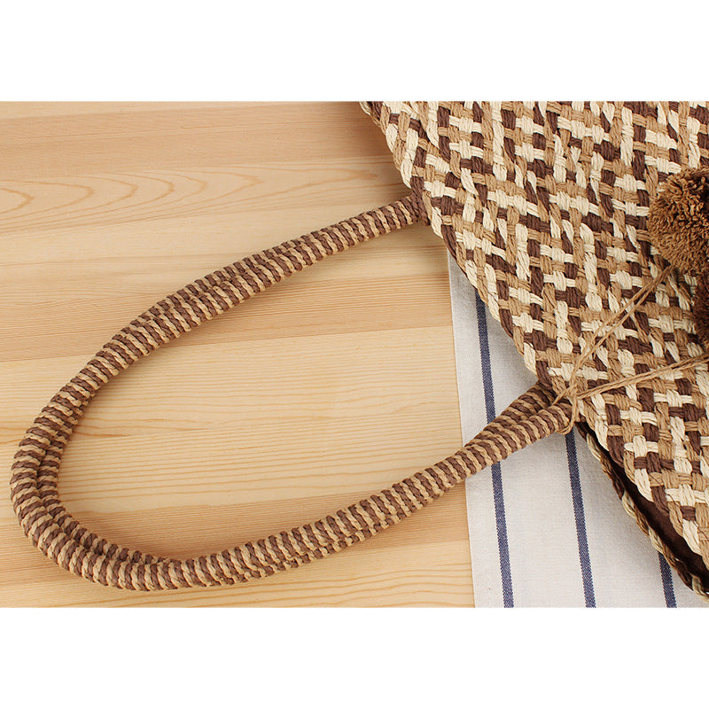 Fashionable basket bag with decorative pompons Kalsten