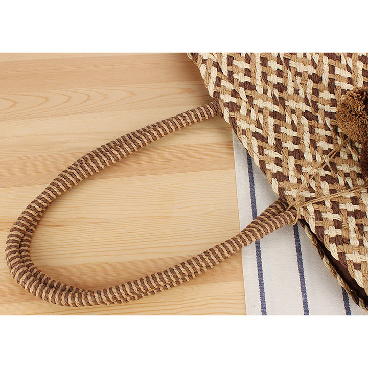 Fashionable basket bag with decorative pompons Kalsten