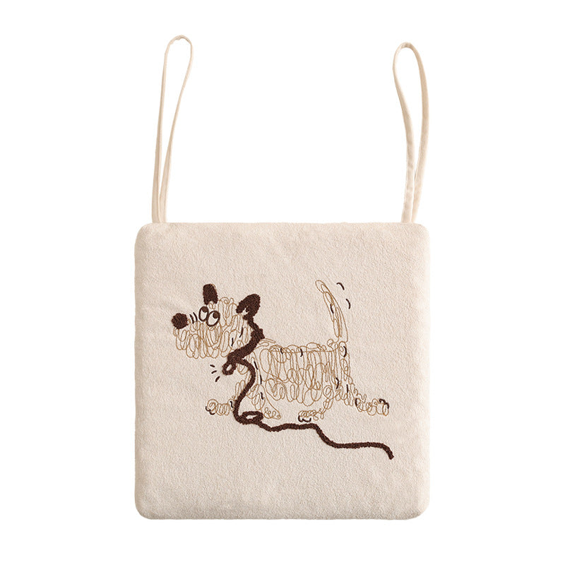 Square seat cushion with ties and embroidered dog motif