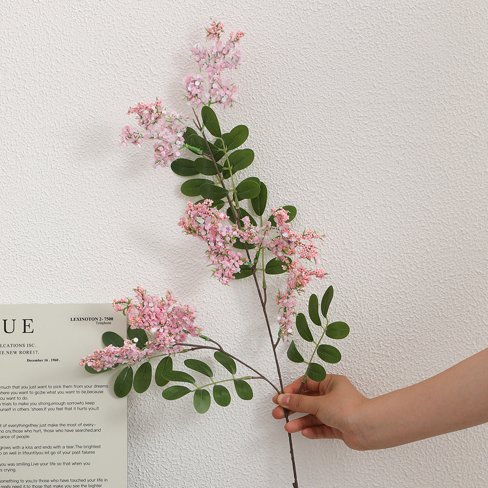 Artificial flower branch with vibrant purple flowers