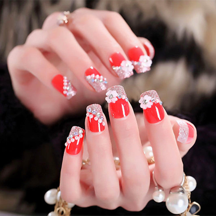 Artificials nails with sparkling rhinestone accents and elegant flower embellishments Kalsten