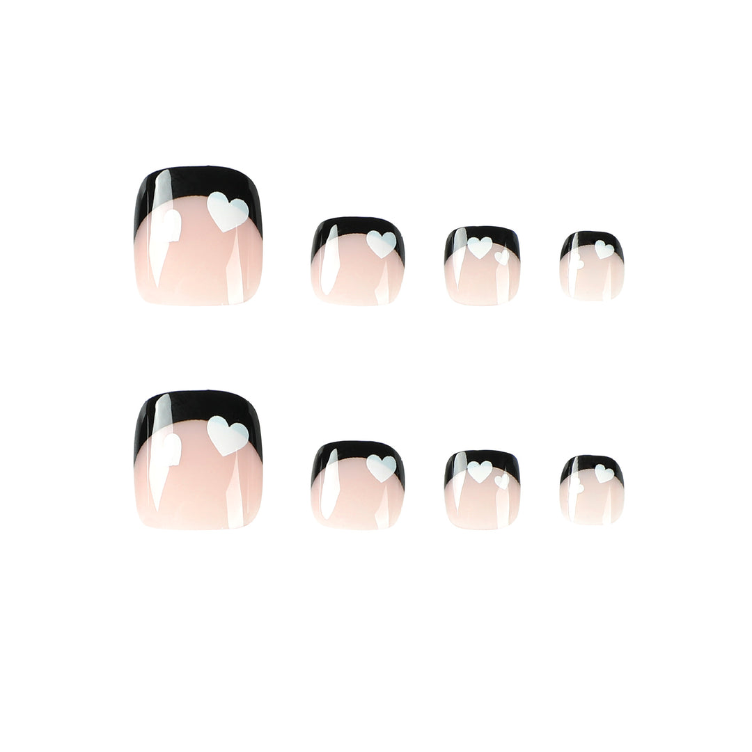 Artistic toenail design with heart motifs and modern black-and-white design Kalsten