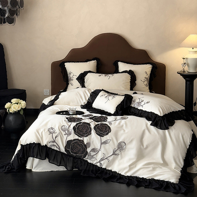 Luxurious bedding set with rose embroidery and ruffled hem