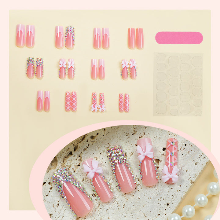 Acrylic nail set with luxurious rhinestone embellishments and bow accents Kalsten