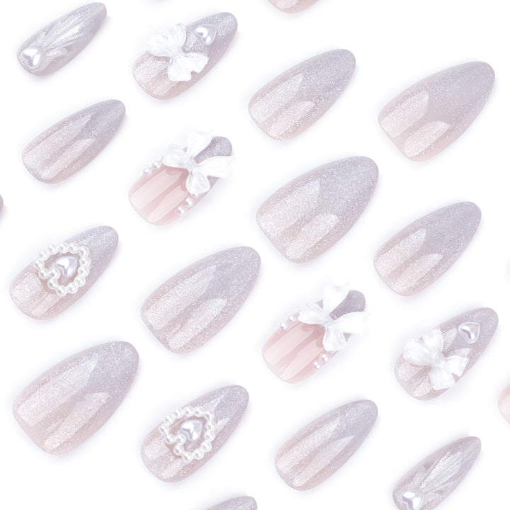 Artful nail decoration with pearl and bow accents Kalsten