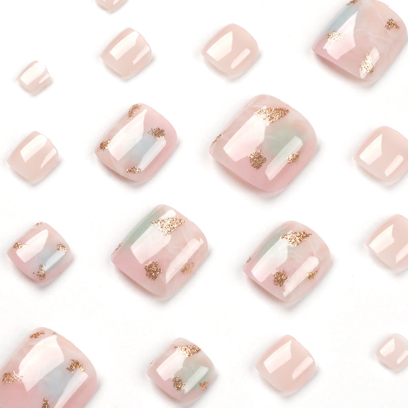 Artful toenail art with elegant marble and gold accents Kalsten