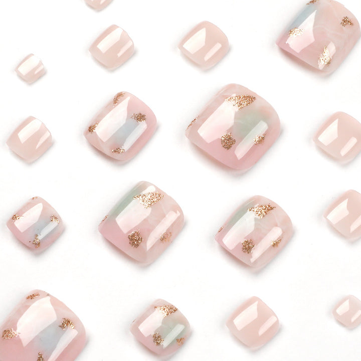Artful toenail art with elegant marble and gold accents Kalsten