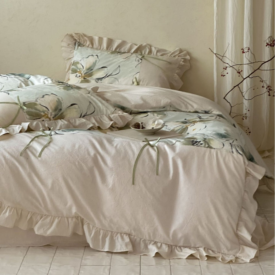 Duvet cover set made of cotton satin with watercolor magnolia print, ruffle, and tie ribbons
