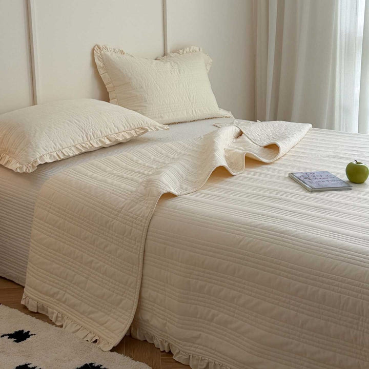 Quilted bedspread with frill and fine line quilting made of cotton blend fabric