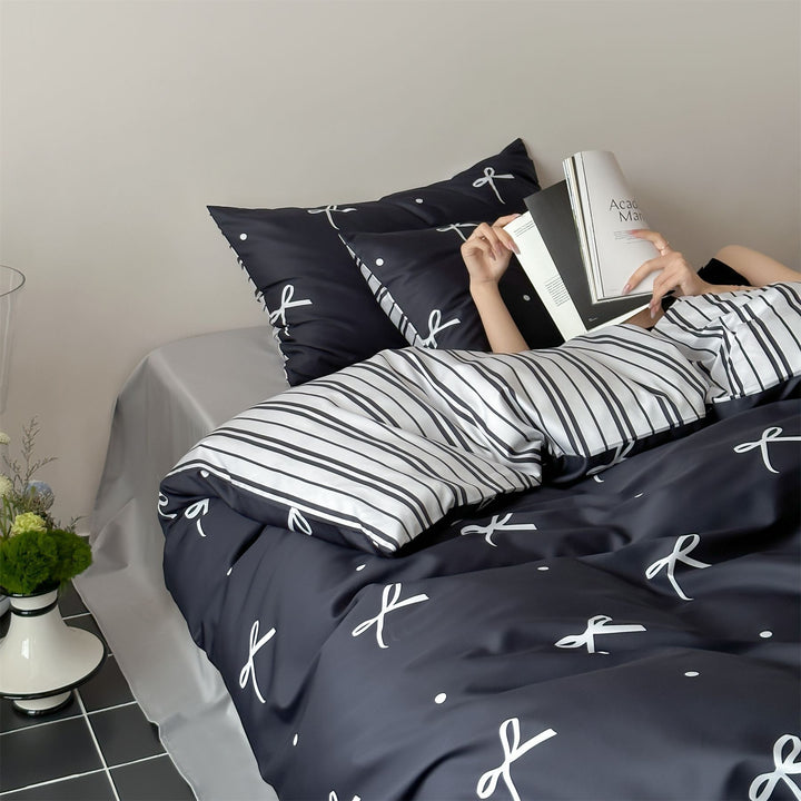 Modern cotton bedding set with minimal bow print and striped reversible side
