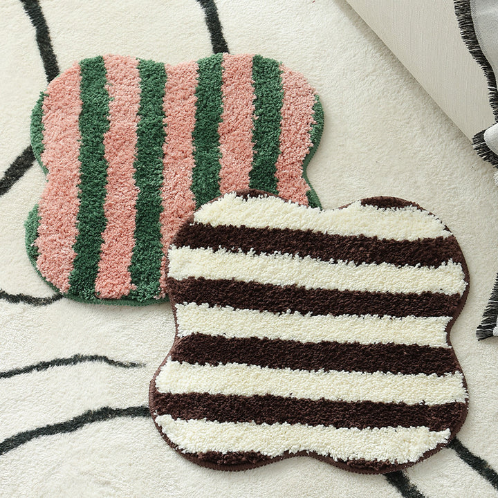 Shaped high pile bath mat with diagonal stripe structure