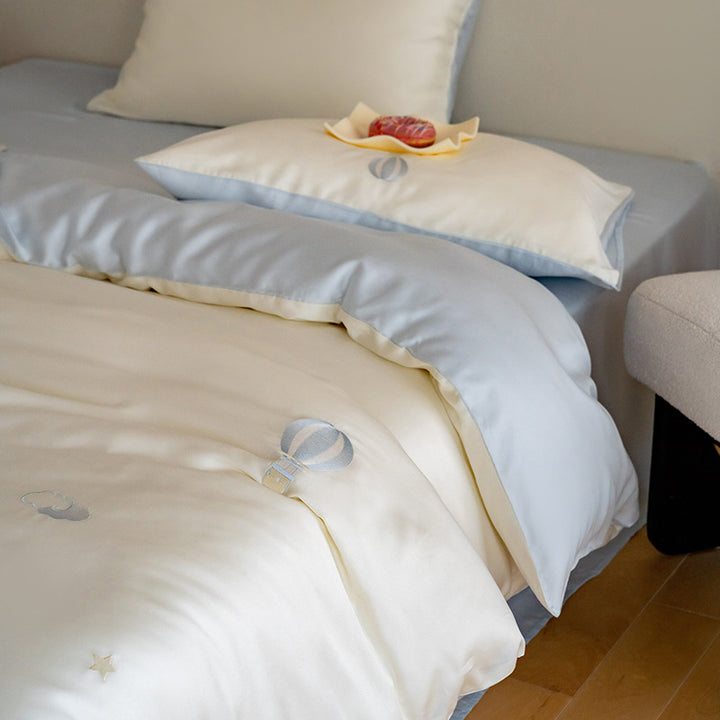 Luxurious satin bedding set with embroidered cherry motifs, reversible function and plush bunny pillow