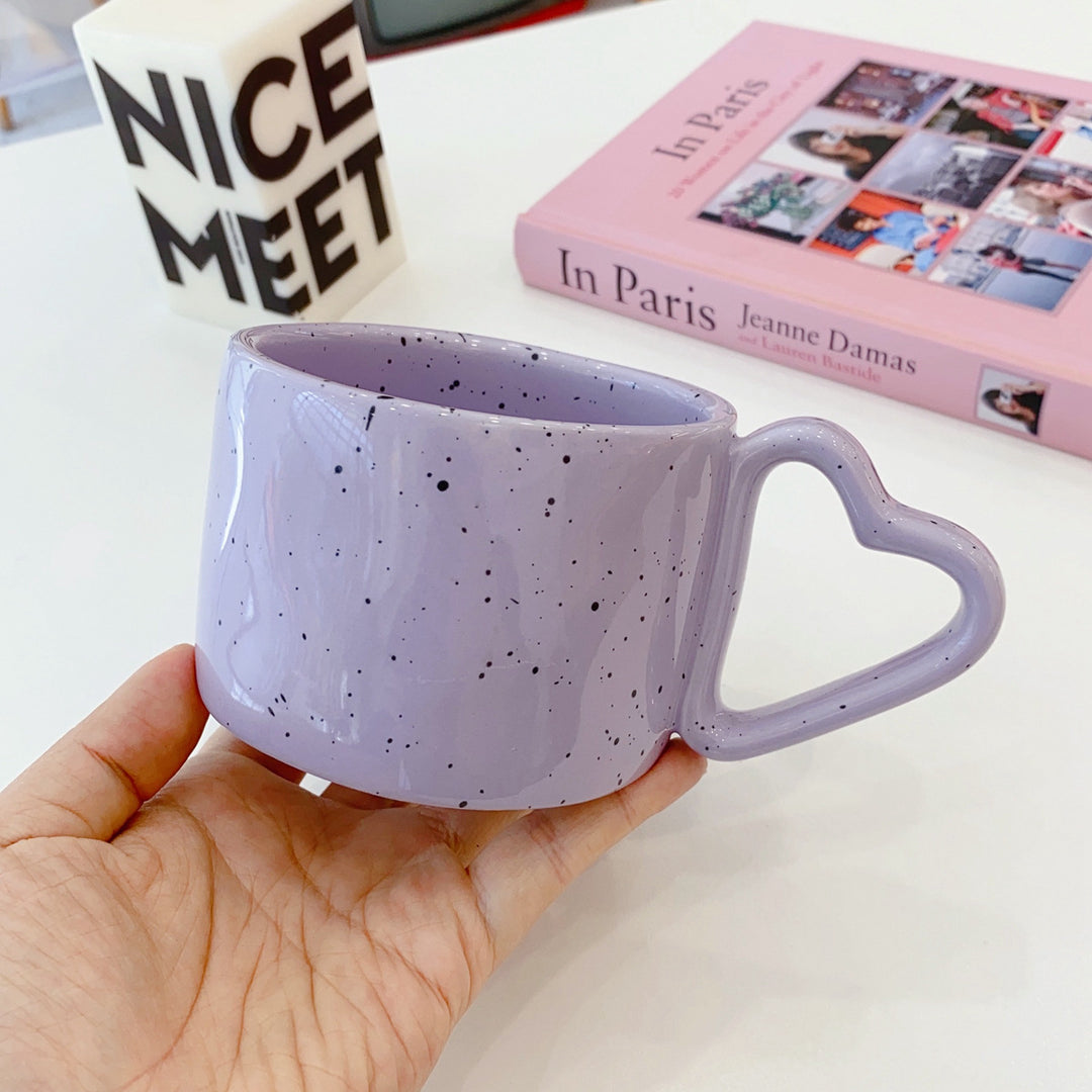 Oversized ceramic mug with heart-shaped handle and dotted glaze