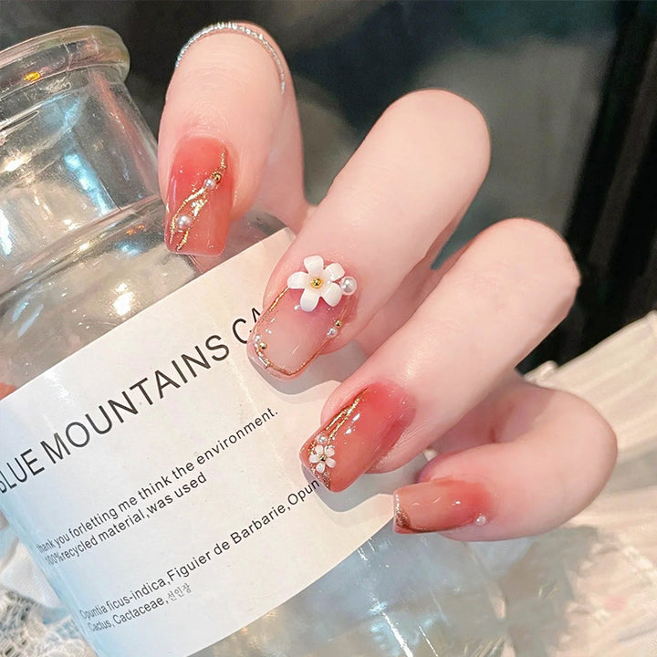 Acrylic nail set with elegant floral decorations and glamorous pearl accents Kalsten