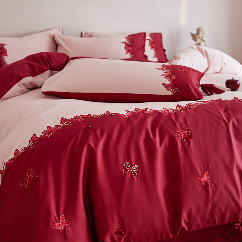 Cotton satin bedding set with butterfly embroidery, decorative bows, and reversible cover