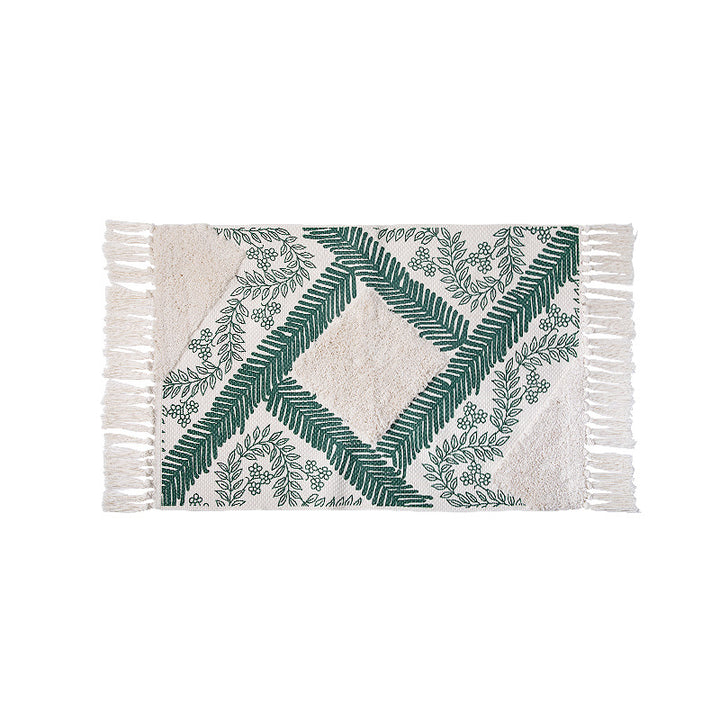 Hand-tufted cotton bath mat with botanical pattern and decorative fringes