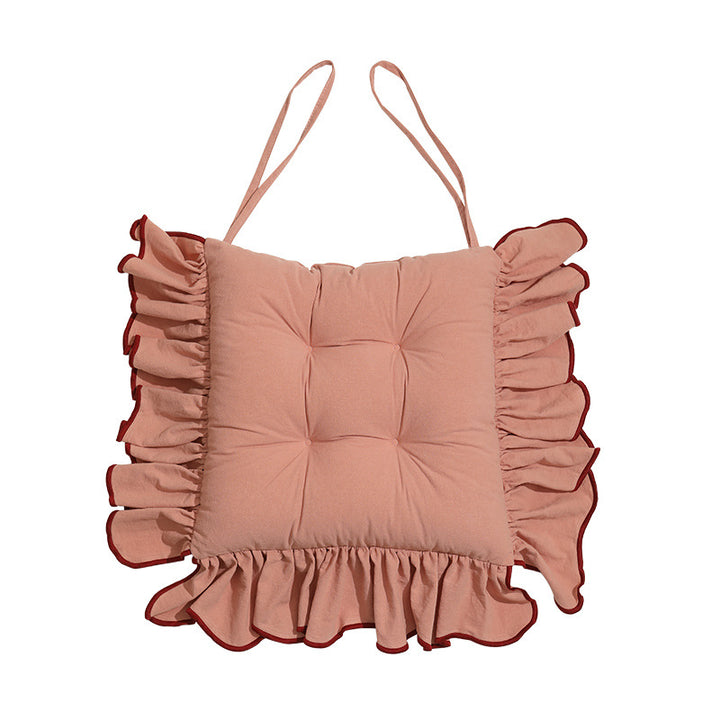 Padded chair cushion with ruffle and fastening bands