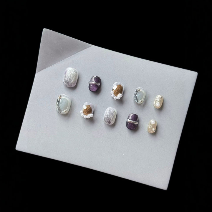 Artistic Press-On Nail Art Set with Unique Textures and Pearl Accents