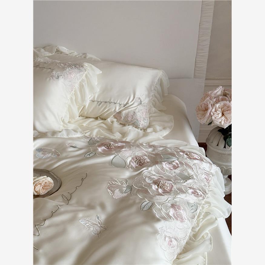 Luxurious satin bed linen set with relief-embroidered rose appliqués and ruffles
