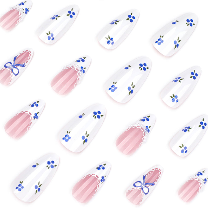 Artful nail art with floral accents and bow embellishment Kalsten