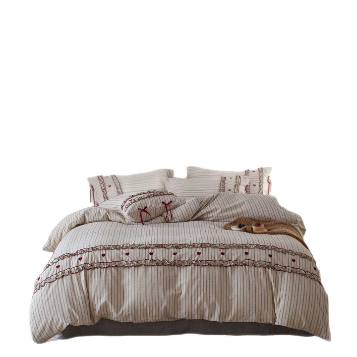 Striped bedding set with ruffles and heart applique