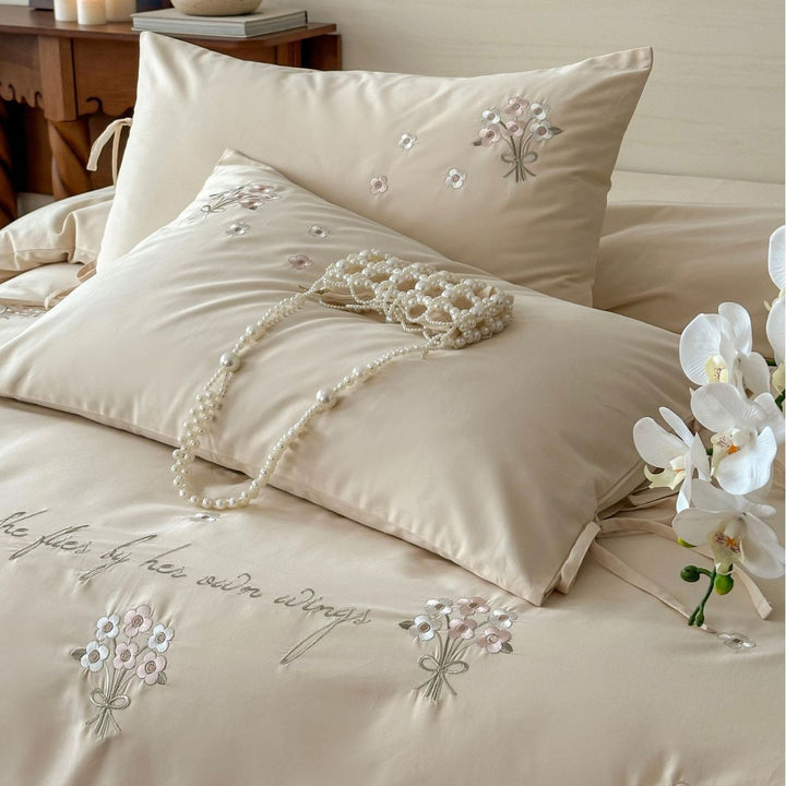 Luxurious satin bedding set with delicate pearl flower embroidery and tie ribbons