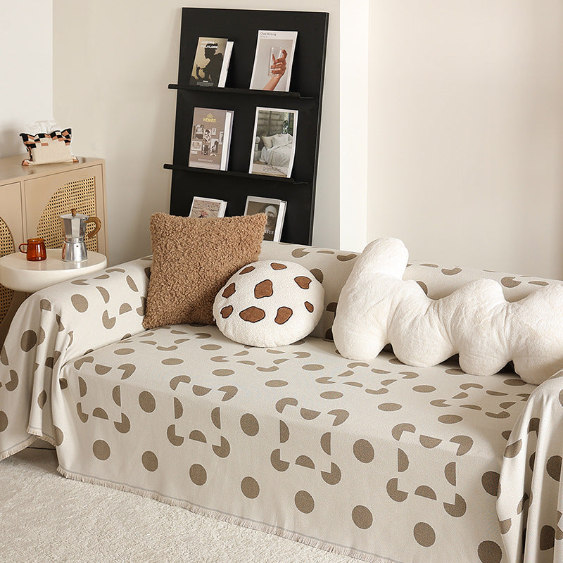 three-seater universal protective cover made of jacquard fabric with geometric pattern