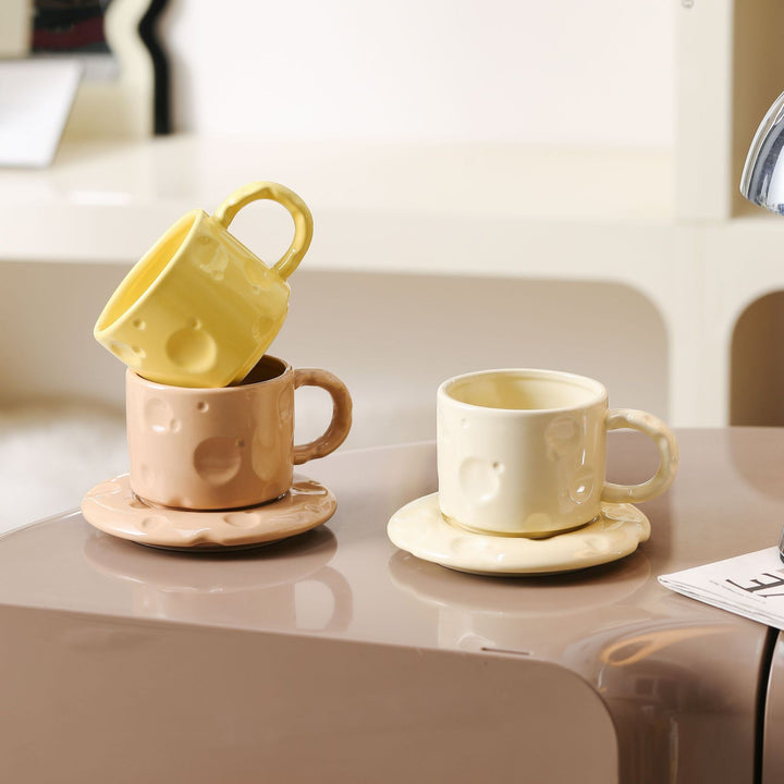 Sculptural ceramic cup set with flowing glaze and textured saucer