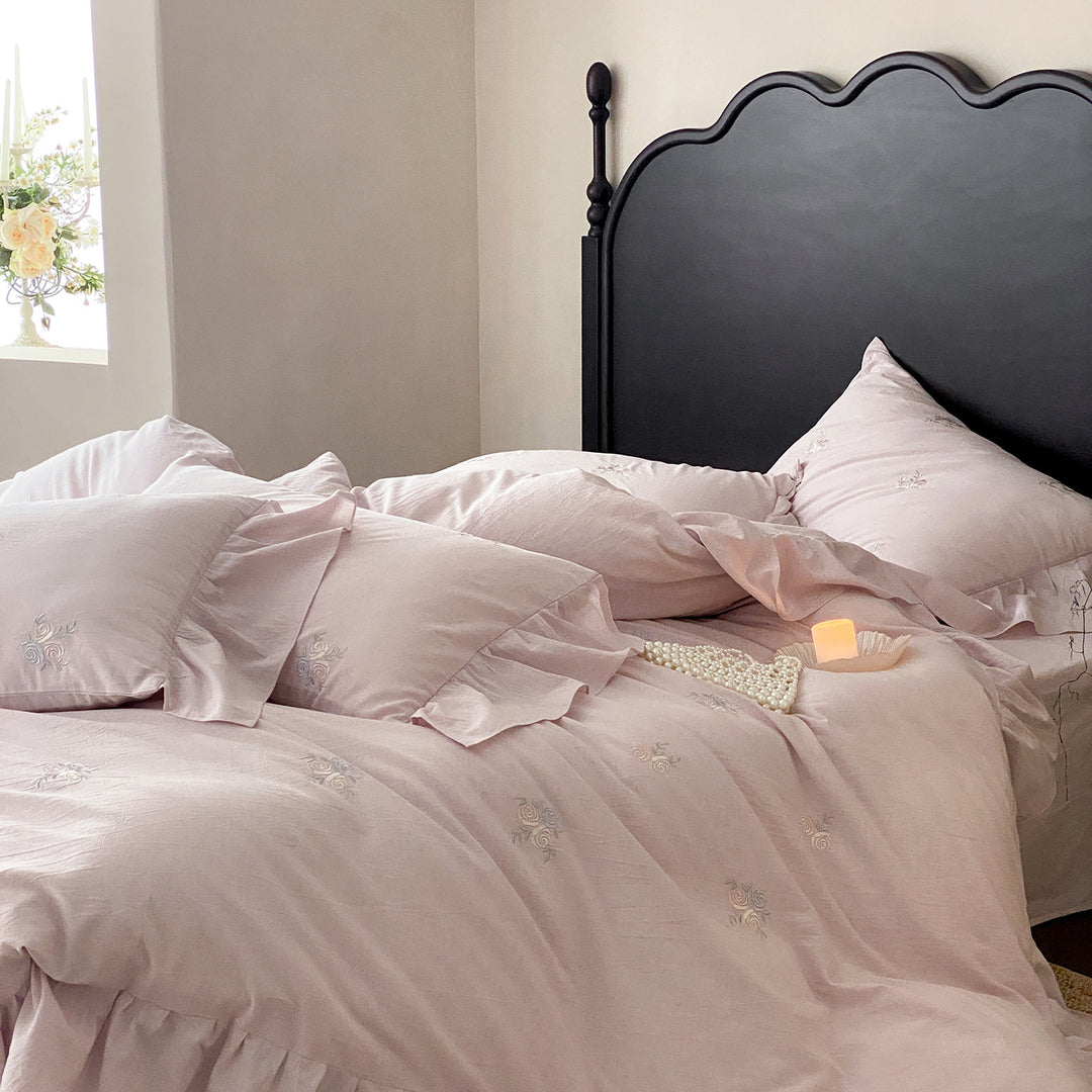 Vintage-inspired linen bedding set with fine rose embroidery and soft wash finish