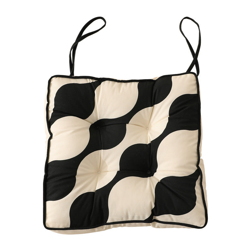 Padded chair cushion with ties and quilted tufted upholstery