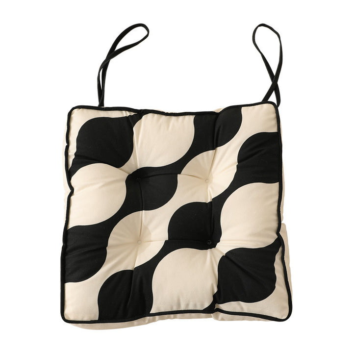 Padded chair cushion with ties and quilted tufted upholstery