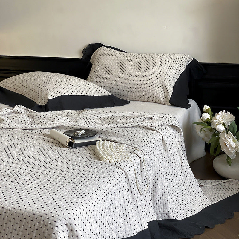 Quilted bedspread and pillowcase set with waffle texture and contrasting ruffle