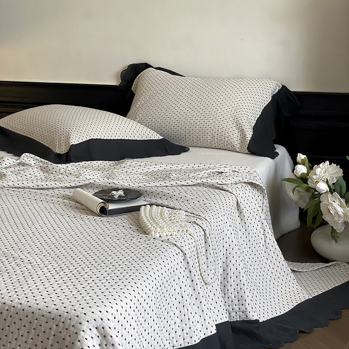 Quilted bedspread and pillowcase set with waffle texture and contrasting ruffle