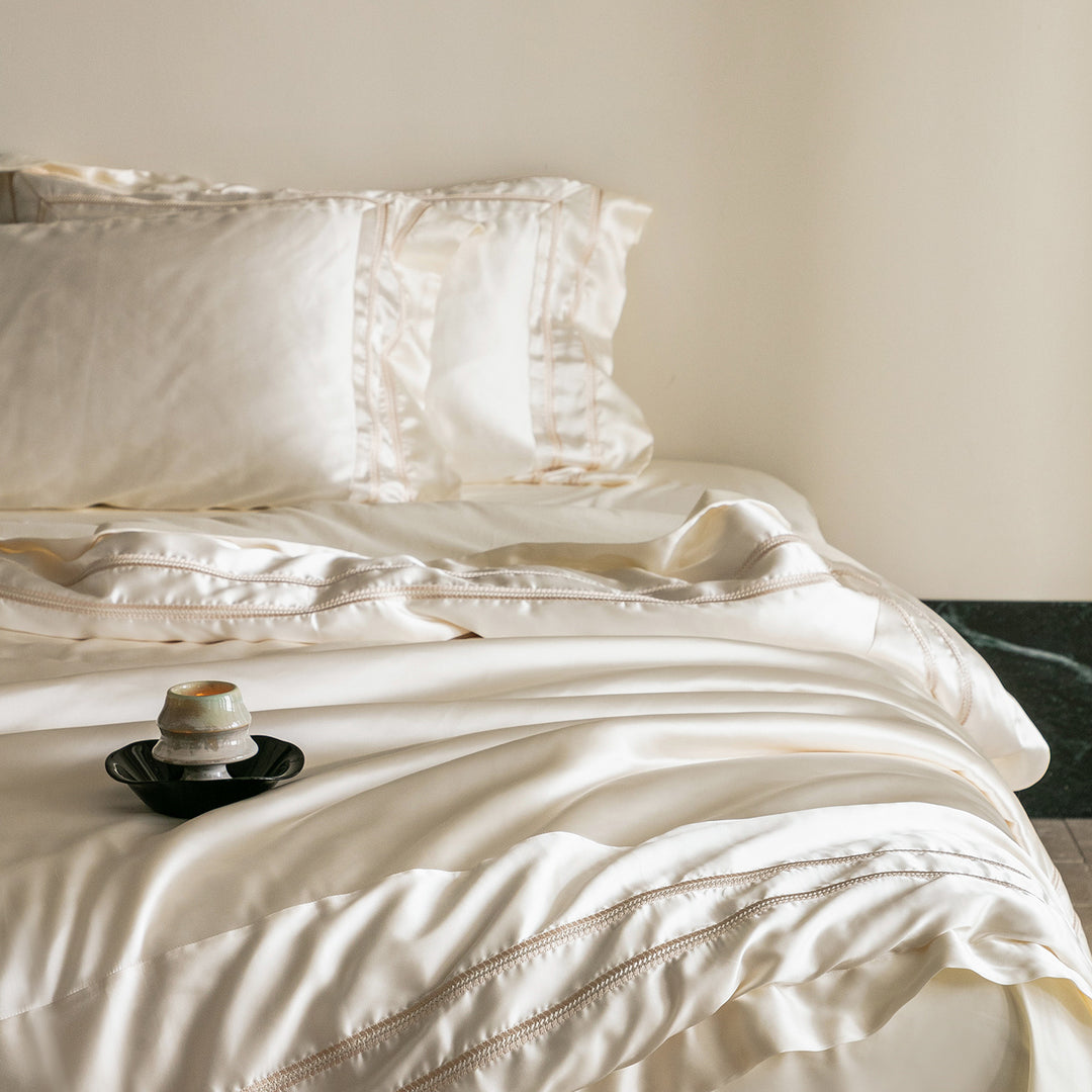 Luxurious satin bedding set with decorative borders and silky-smooth feel