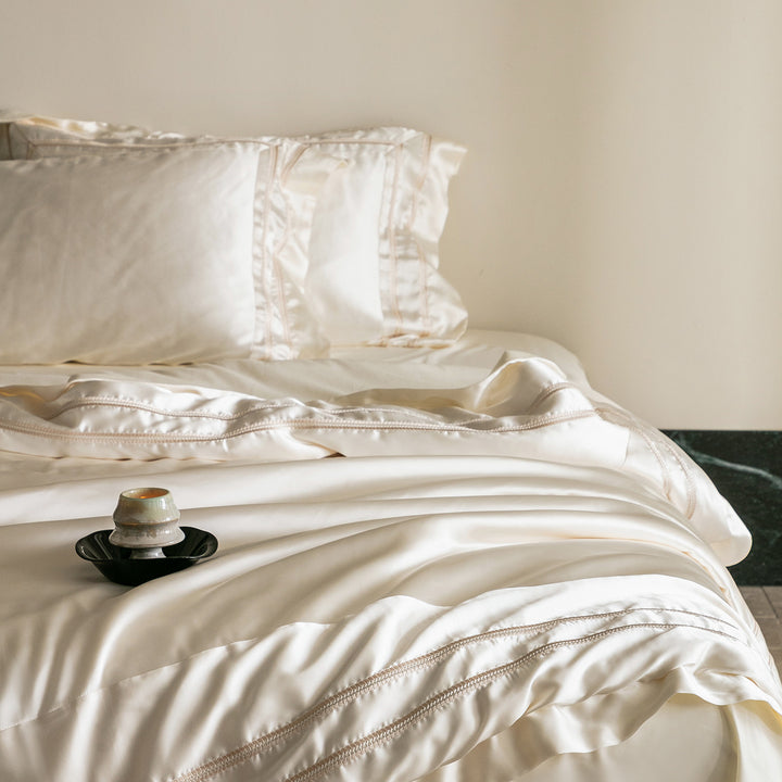 Luxurious satin bedding set with decorative borders and silky-smooth feel