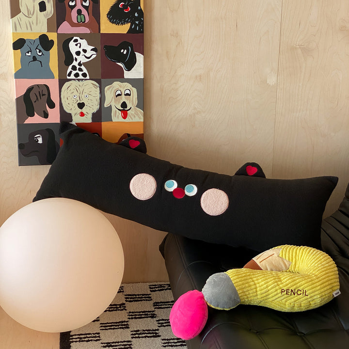 Extra-long plush sofa cushion with appliqués and plush feet